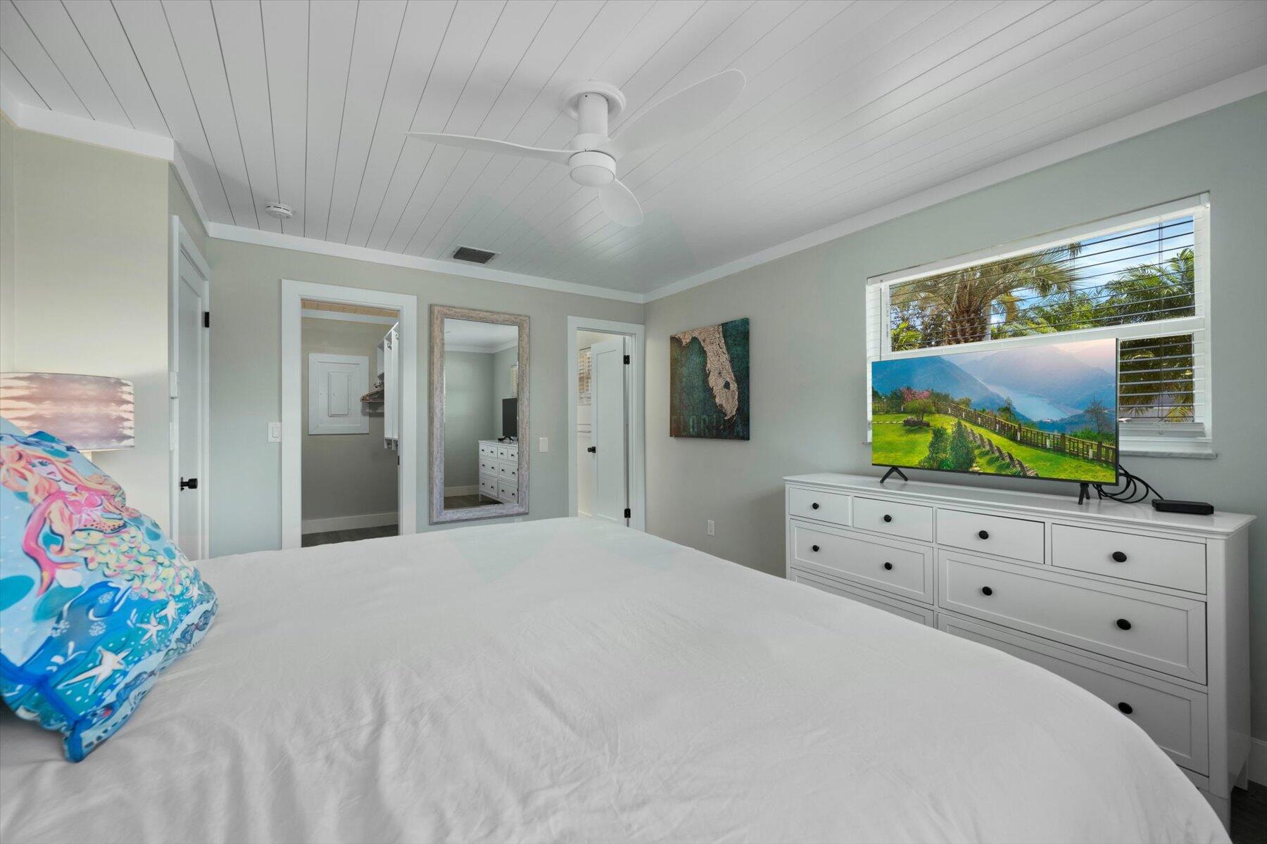1389 Southwest Dyer Point Road Palm City, FL 34990 - Photo 24 of 55 a bedroom with furniture and flat screen tv