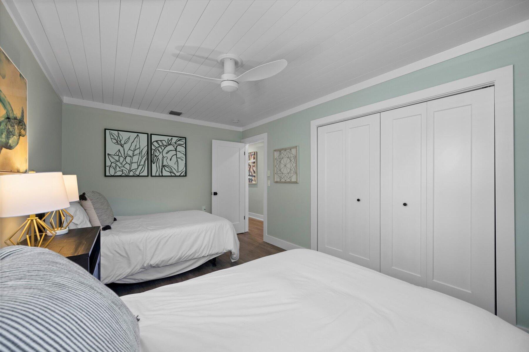 1389 Southwest Dyer Point Road Palm City, FL 34990 - Photo 26 of 55 a bedroom with two beds and a lamp