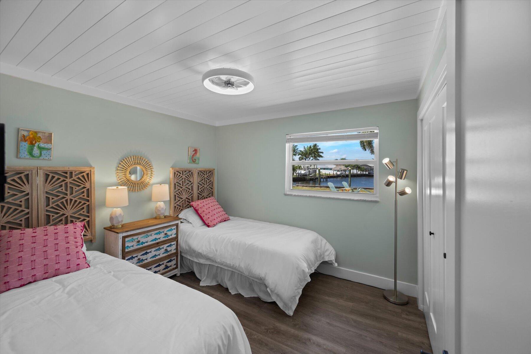 1389 Southwest Dyer Point Road Palm City, FL 34990 - Photo 27 of 55 a bedroom with two beds and a dresser