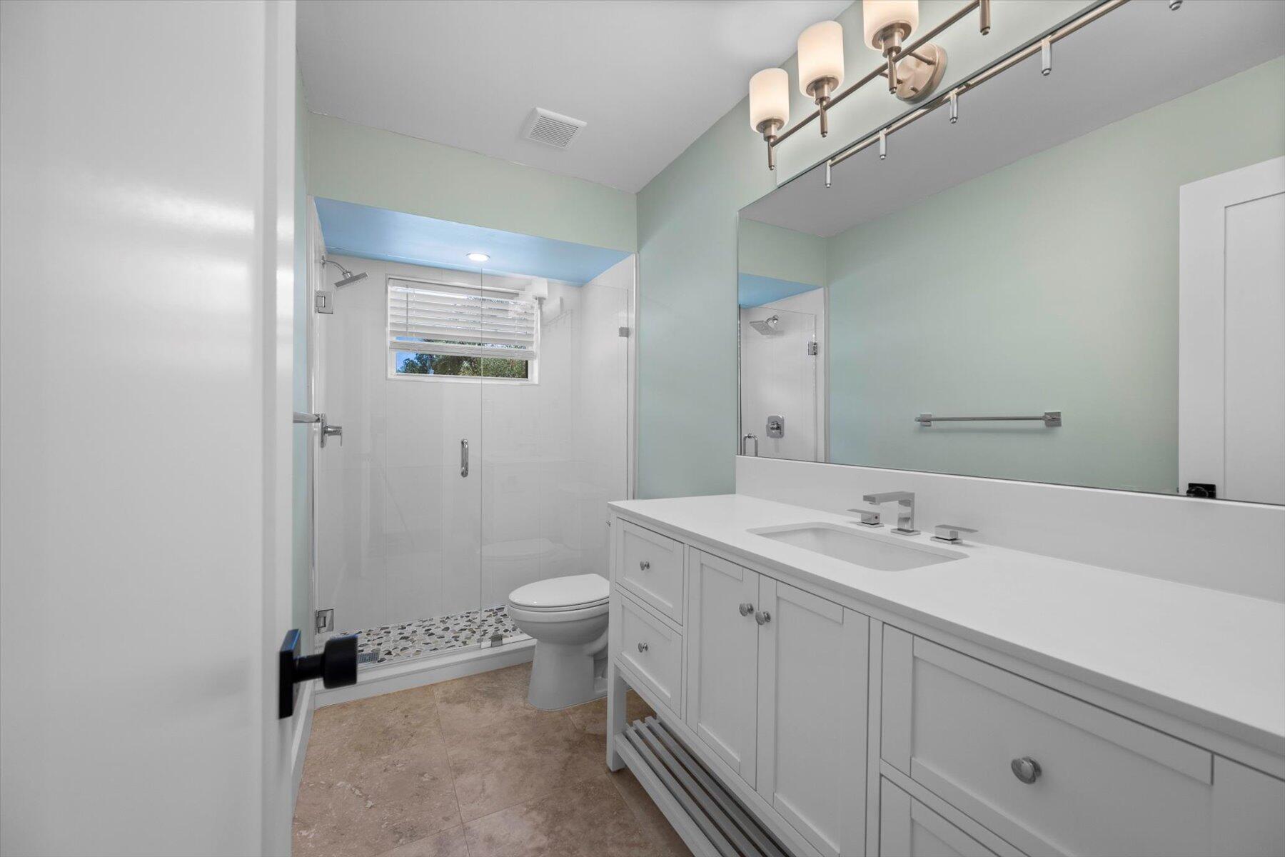 1389 Southwest Dyer Point Road Palm City, FL 34990 - Photo 29 of 55 a bathroom with a sink a toilet and shower