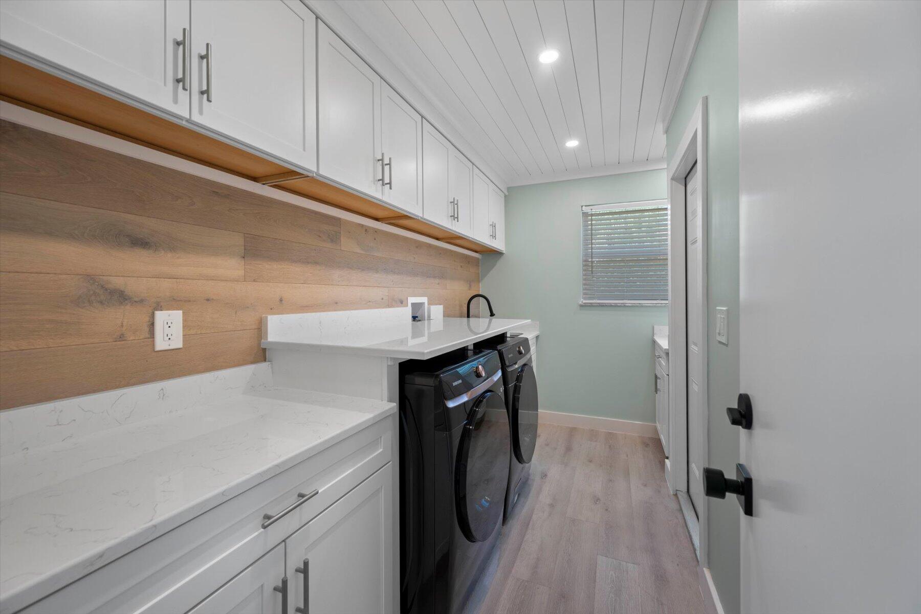 1389 Southwest Dyer Point Road Palm City, FL 34990 - Photo 30 of 55 a utility room with cabinets washer and dryer