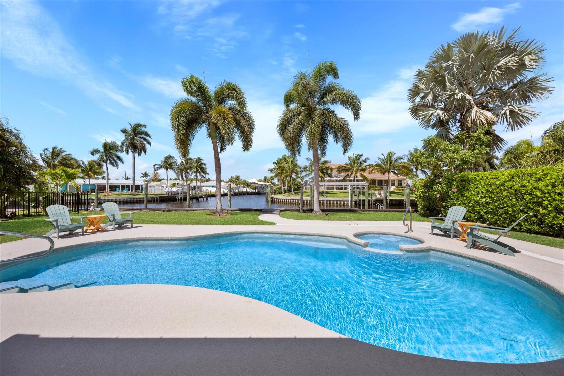 1389 Southwest Dyer Point Road Palm City, FL 34990 - Photo 33 of 55 a view of outdoor space with swimming pool and lounge chair