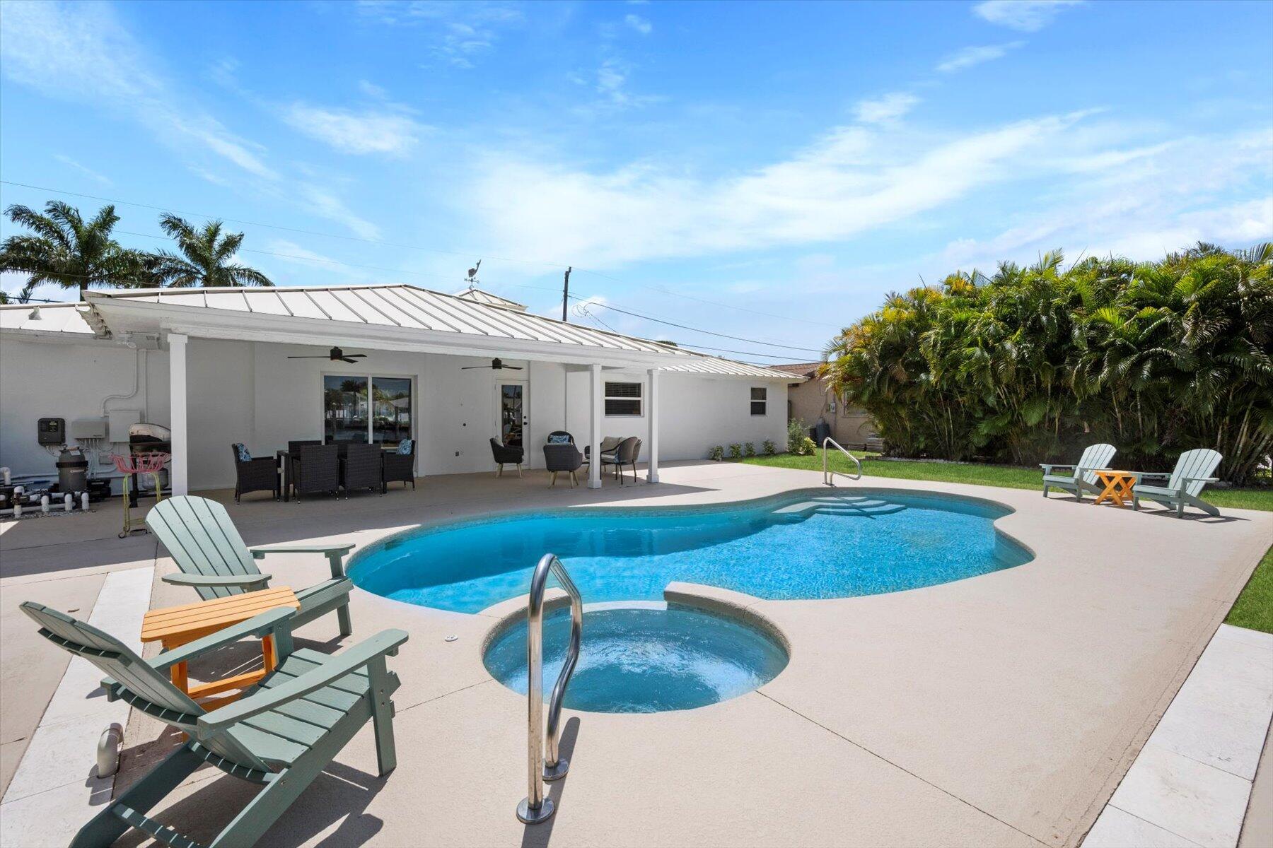 1389 Southwest Dyer Point Road Palm City, FL 34990 - Photo 34 of 55 a view of a house with swimming pool and sitting area
