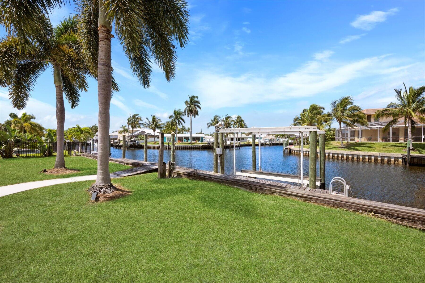 1389 Southwest Dyer Point Road Palm City, FL 34990 - Photo 40 of 55 a park with lots of palm trees and swing
