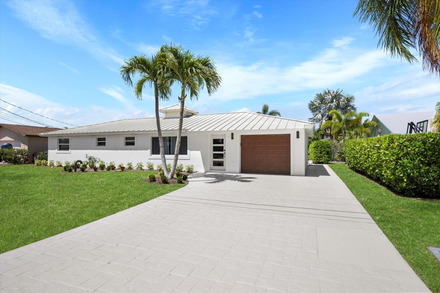 1389 Southwest Dyer Point Road Palm City, FL 34990 - Photo 4 of 55 a front view of house with yard and green space