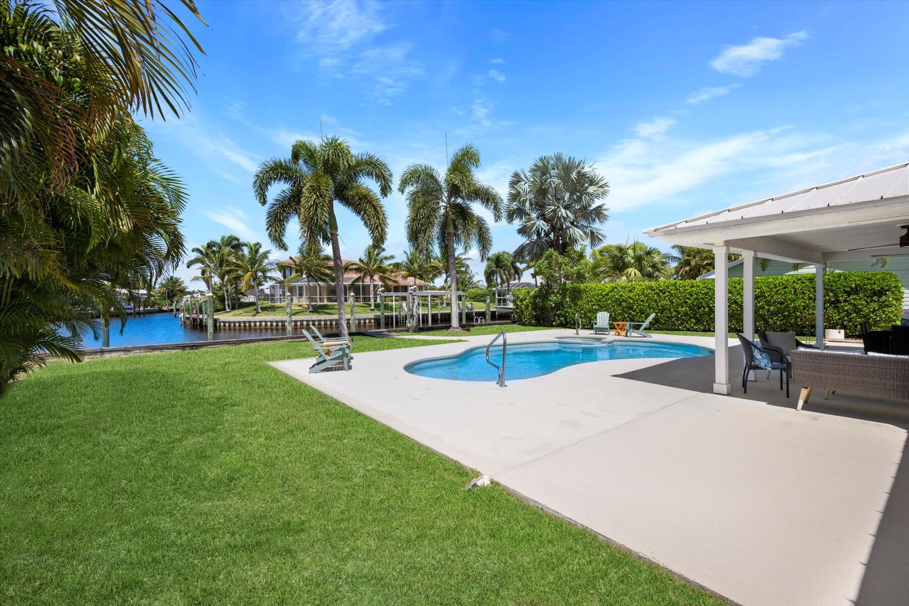 1389 Southwest Dyer Point Road Palm City, FL 34990 - Photo 44 of 55 a view of a swimming pool and a yard