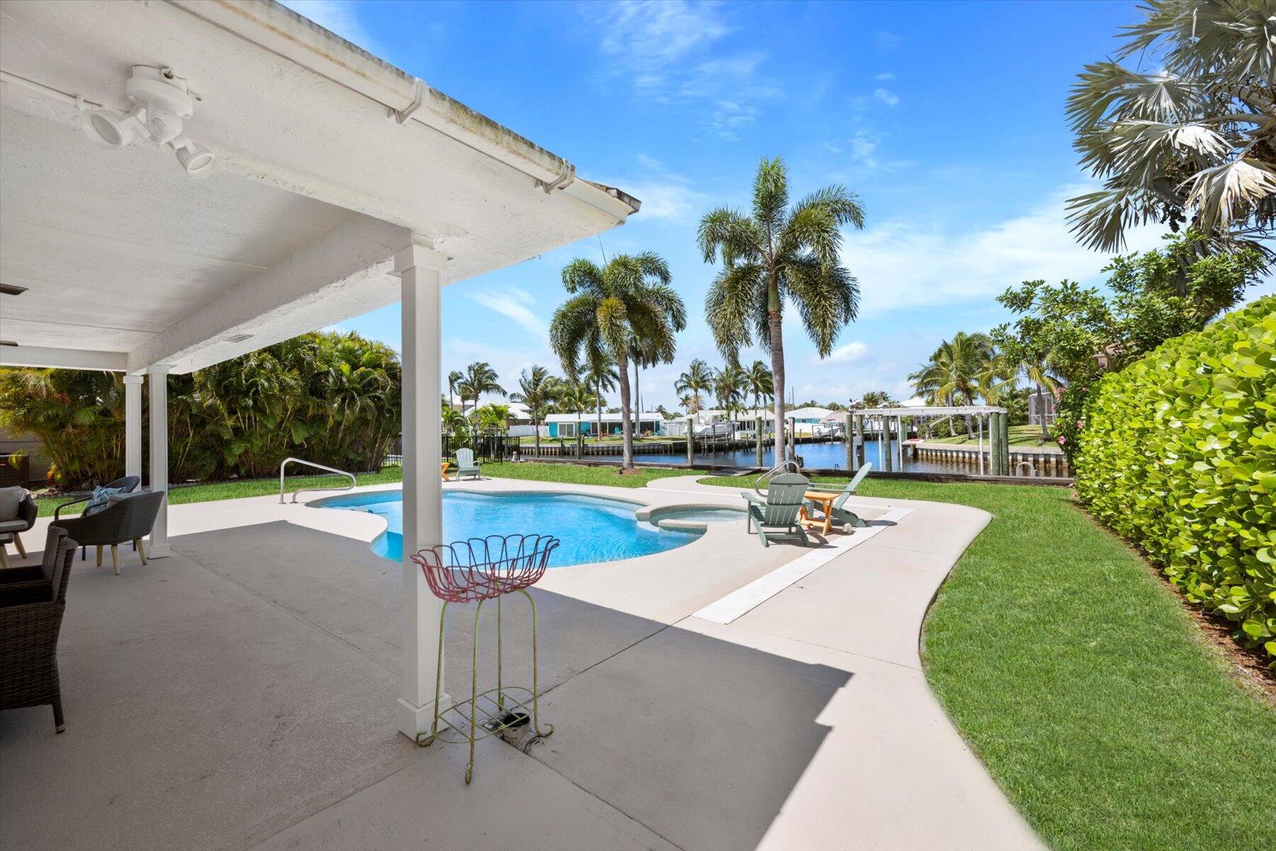 1389 Southwest Dyer Point Road Palm City, FL 34990 - Photo 45 of 55 a view of a swimming pool with a patio