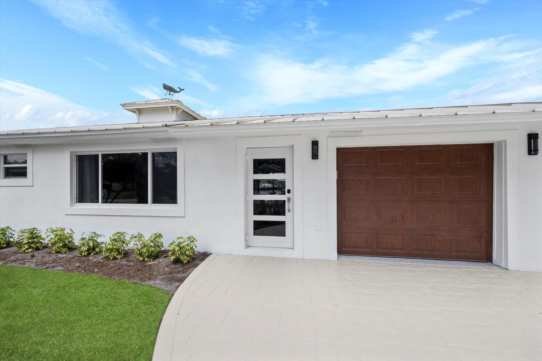 1389 Southwest Dyer Point Road Palm City, FL 34990 - Photo 46 of 55 a front view of a house with a yard
