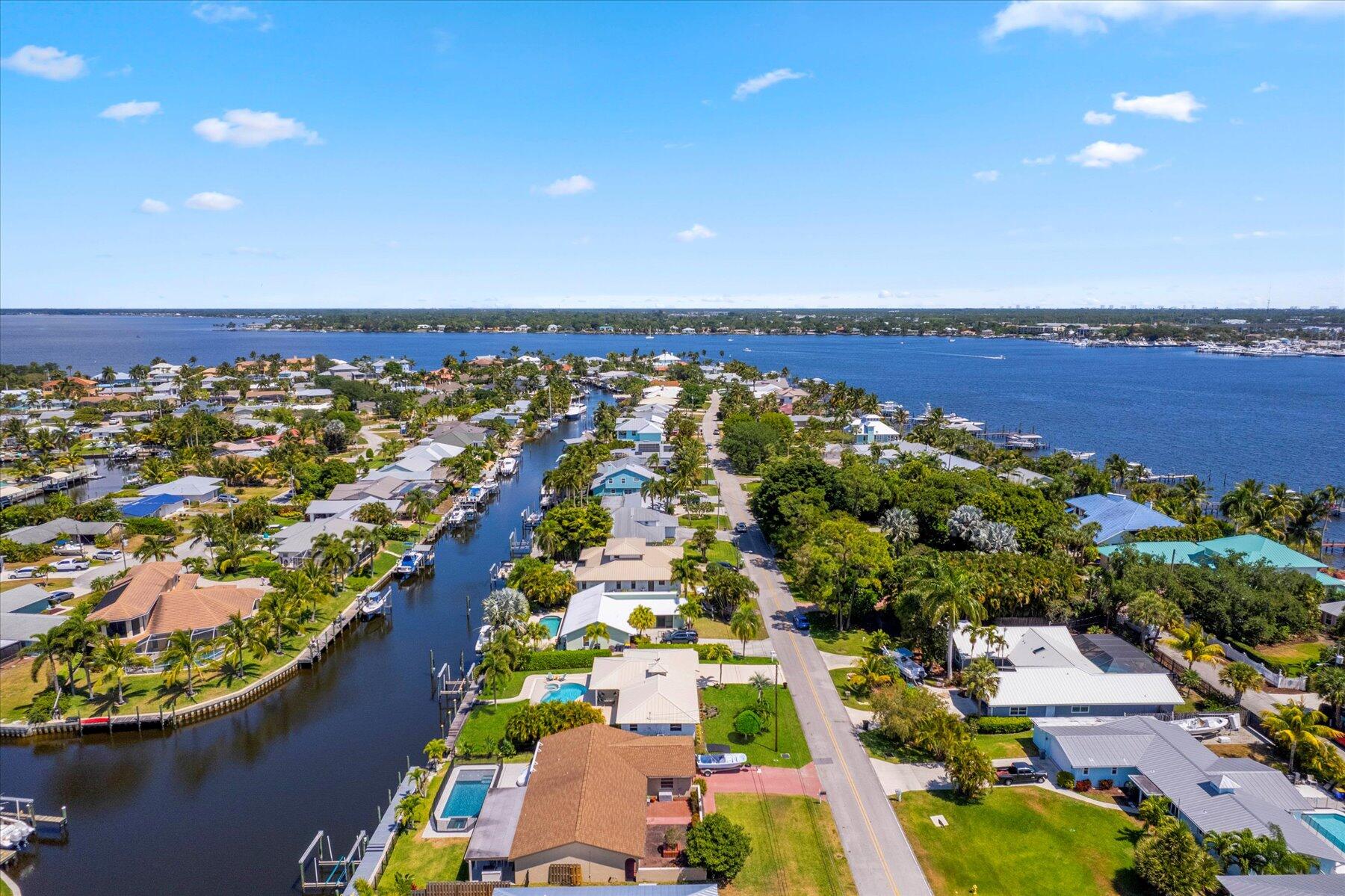 1389 Southwest Dyer Point Road Palm City, FL 34990 - Photo 50 of 55 an aerial view of residential houses with outdoor space and swimming pool