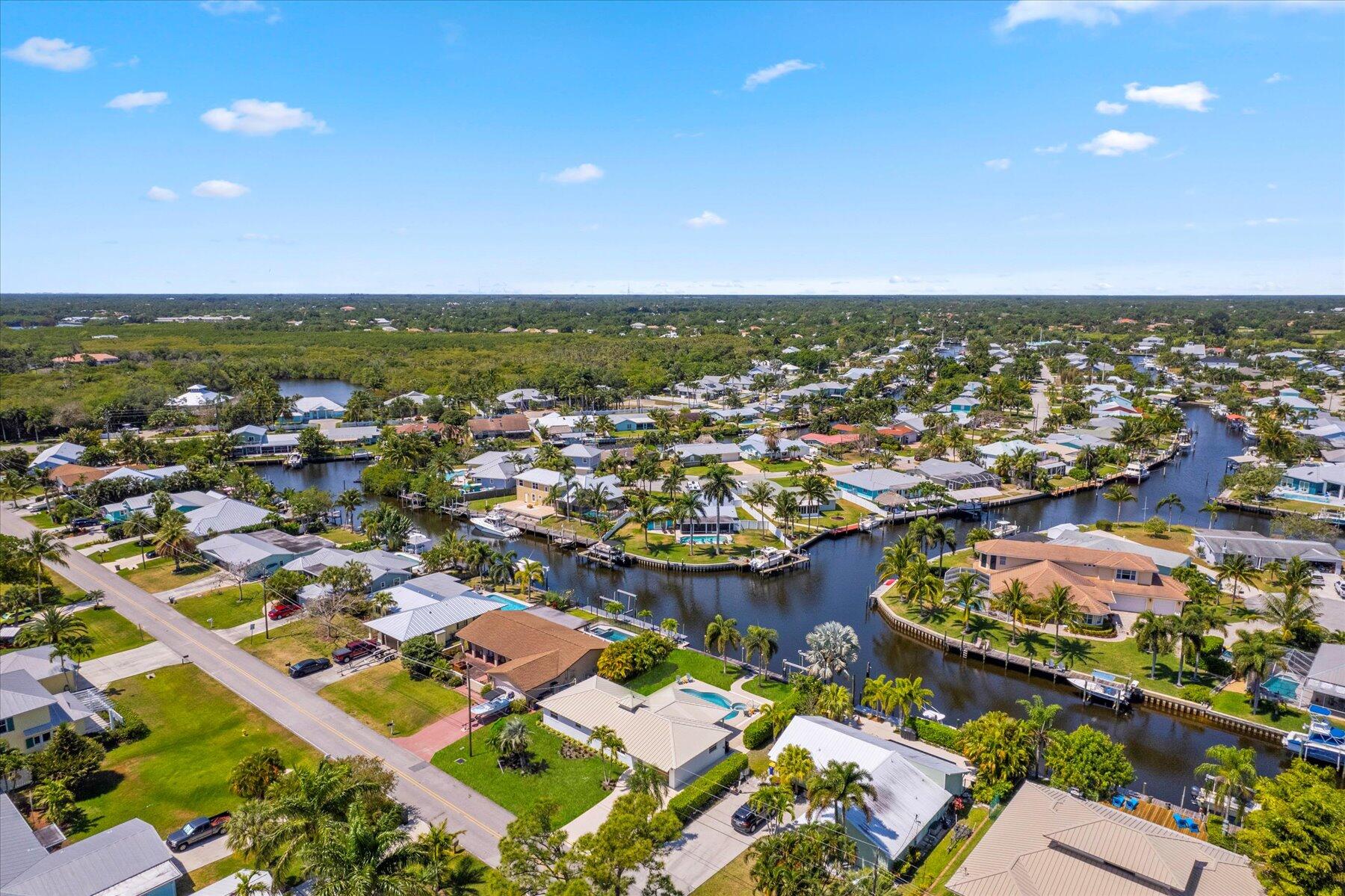 1389 Southwest Dyer Point Road Palm City, FL 34990 - Photo 51 of 55 an aerial view of residential houses with outdoor space