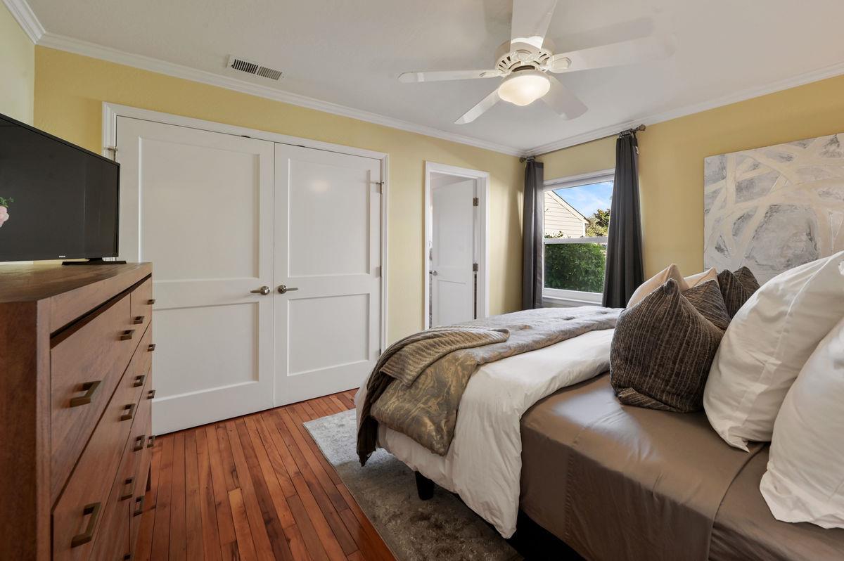 120 Ottawa Street San Mateo, CA 94401 - Photo 11 of 20 a bedroom with a bed and a flat tv screen on dresser