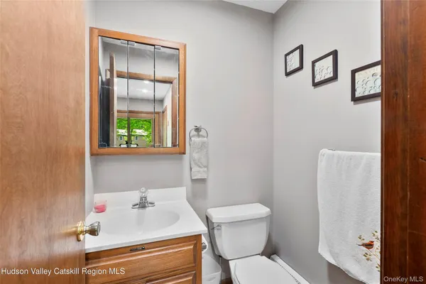 a bathroom with a sink toilet and mirror