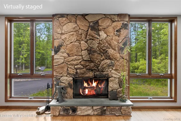a living room with a fireplace and a window