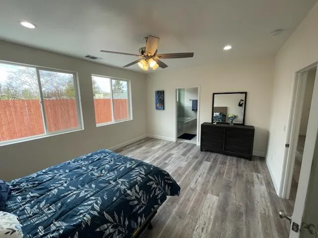 a bedroom with a bed and a large window