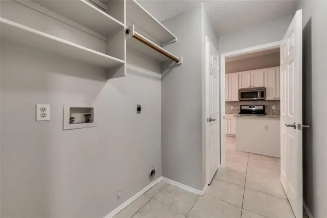 a view of a hallway to closet and cabinet