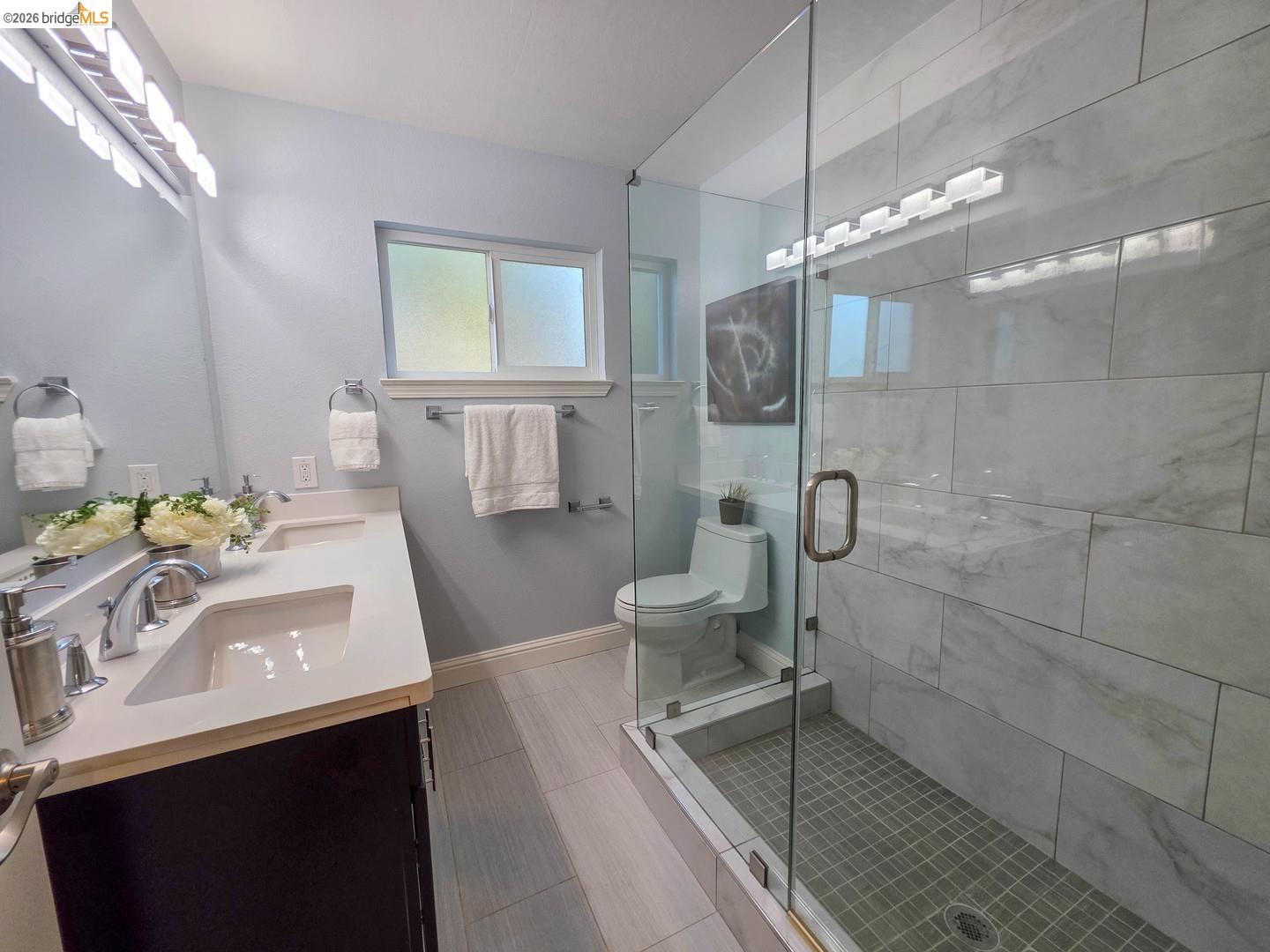 965 Springer Road Los Altos, CA 94024 - Photo 25 of 31 Contemporary bathroom featuring a frameless glass shower enclosure with white tiled walls and a mosaic tile floor