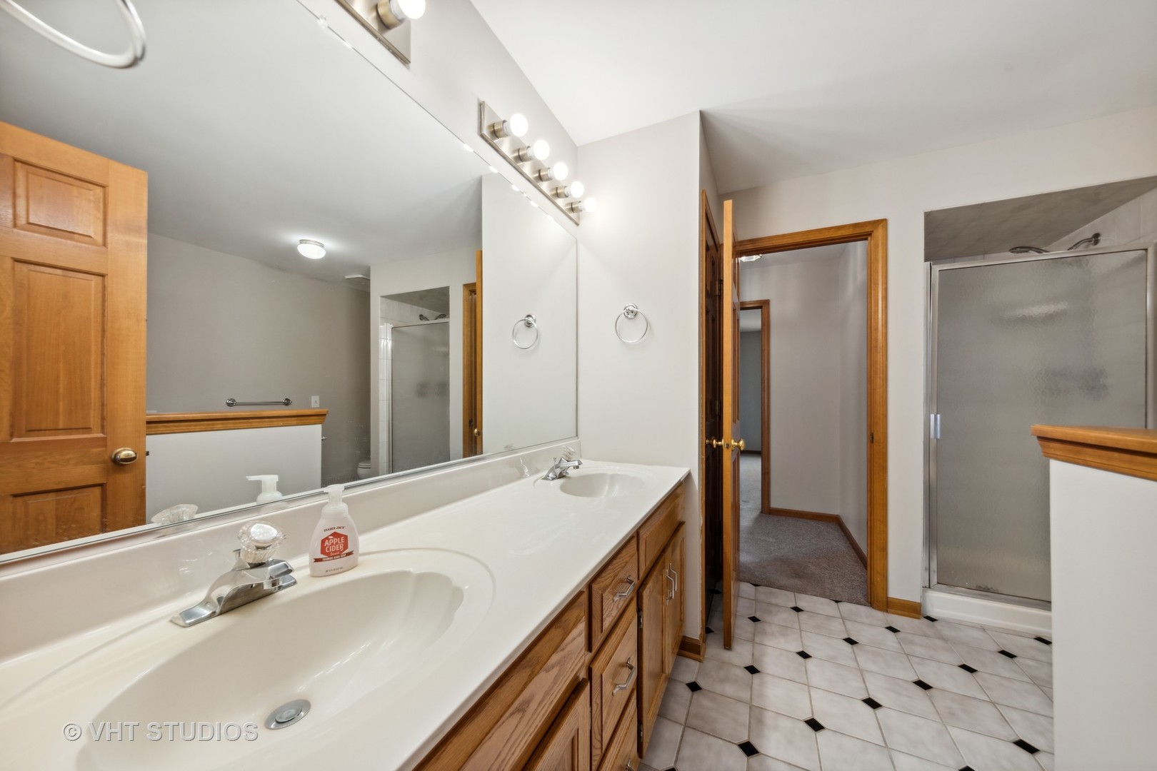 S023 Quail Run Court Winfield, IL 60190 - Photo 16 of 25 a spacious bathroom with a double vanity sink mirror and shower