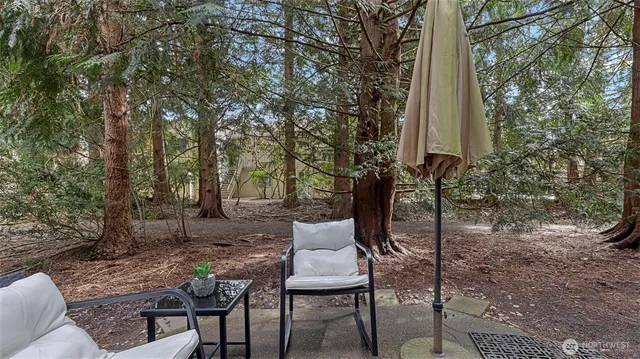 a backyard of a house with table and chairs
