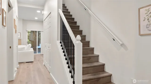 a view of entryway and hall with wooden floor