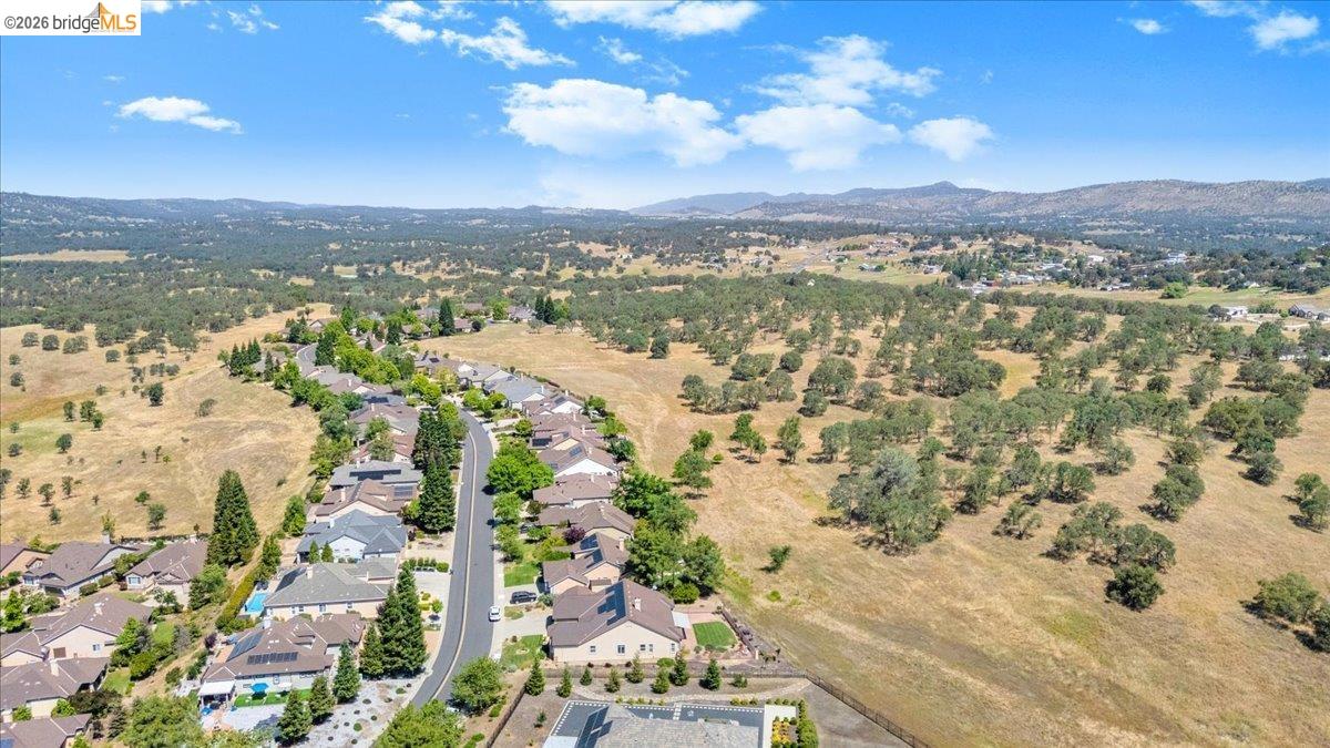 158 Rock Ridge Lane Copperopolis, CA 95228 - Photo 62 of 72 Aerial panorama showcasing a residential street with single-family homes, surrounded by expansive natural landscapes