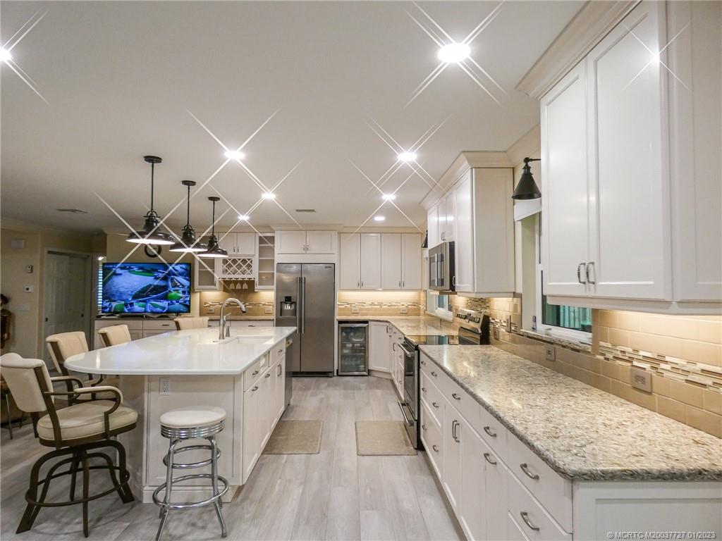 308 Southwest Ridge Lane Stuart, FL 34994 - Photo 15 of 43 a kitchen with lots of counter top space and stainless steel appliances