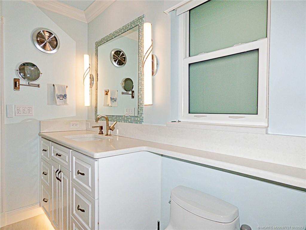 308 Southwest Ridge Lane Stuart, FL 34994 - Photo 20 of 43 a bathroom with a sink a mirror and a toilet