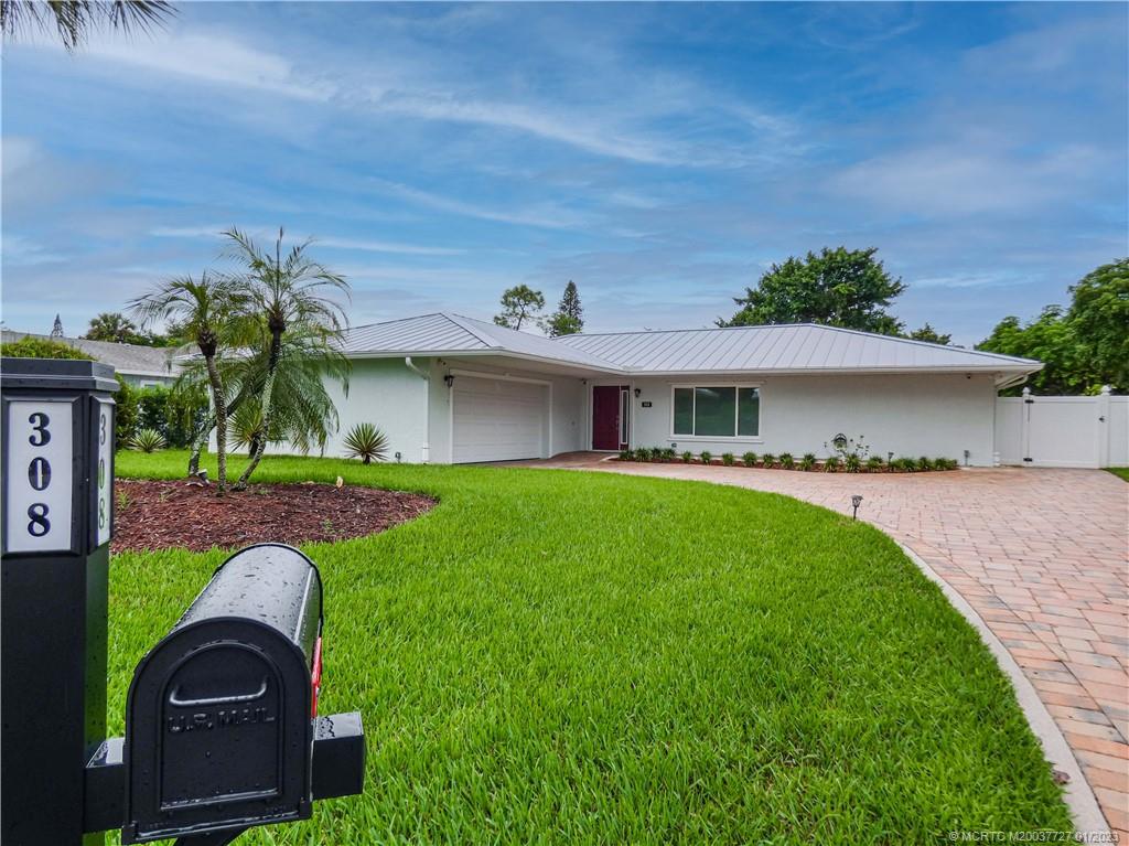308 Southwest Ridge Lane Stuart, FL 34994 - Photo 2 of 43 a front view of a house with garden