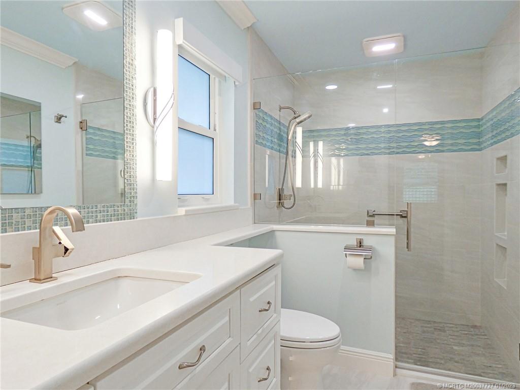 308 Southwest Ridge Lane Stuart, FL 34994 - Photo 22 of 43 a bathroom with a sink a toilet and a mirror