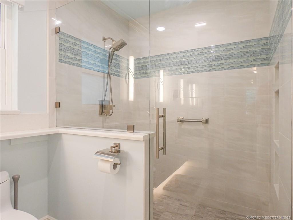 308 Southwest Ridge Lane Stuart, FL 34994 - Photo 23 of 43 a bathroom with a shower and a sink