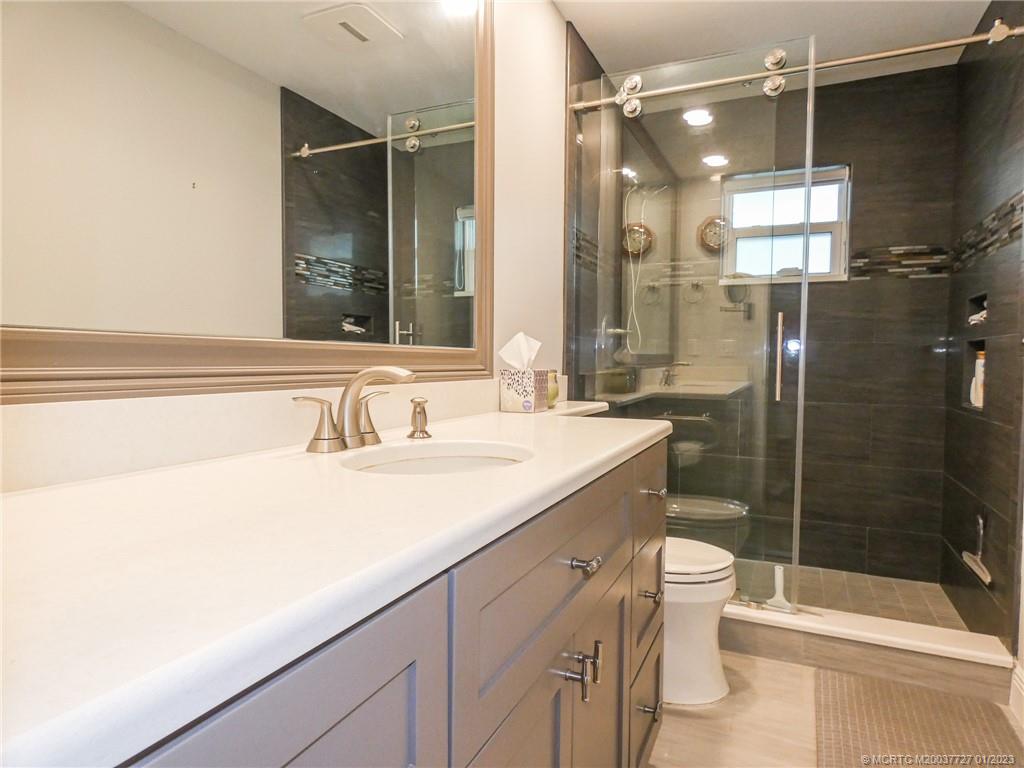 308 Southwest Ridge Lane Stuart, FL 34994 - Photo 26 of 43 a bathroom with a sink toilet and shower