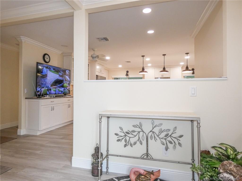 308 Southwest Ridge Lane Stuart, FL 34994 - Photo 4 of 43 a view of kitchen with stainless steel appliances cabinets and wooden floor