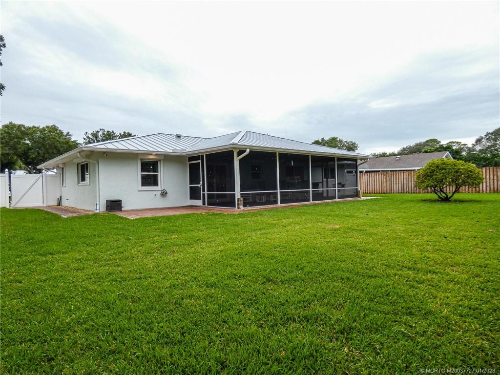 308 Southwest Ridge Lane Stuart, FL 34994 - Photo 42 of 43 a view of a house with a backyard
