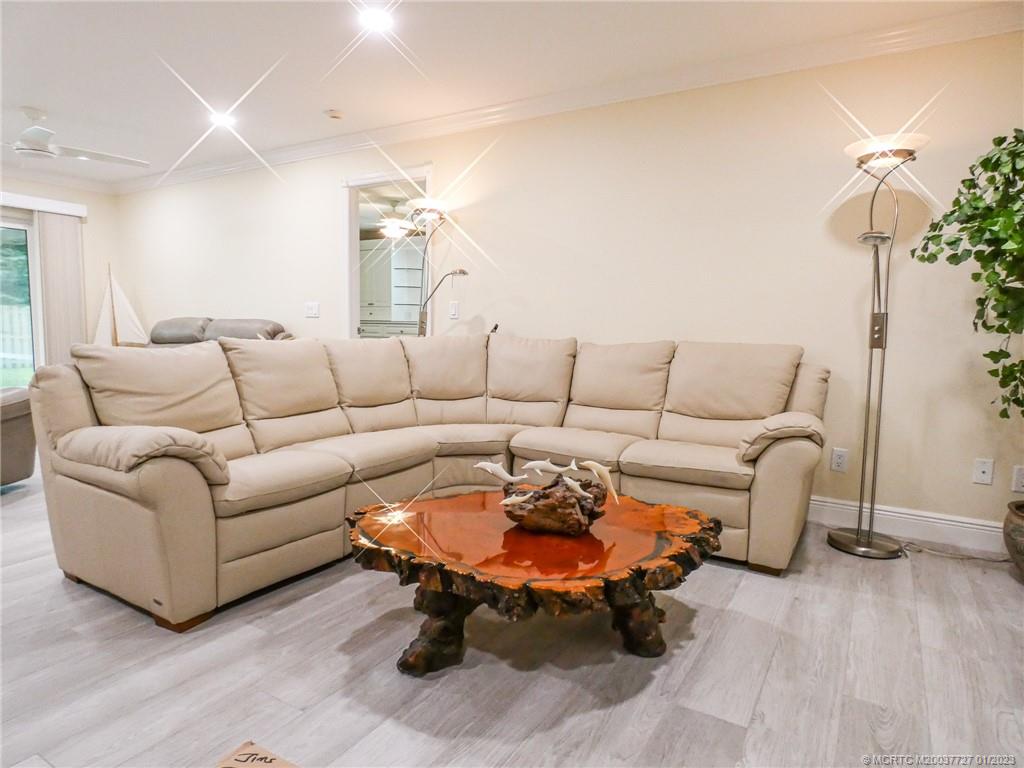 308 Southwest Ridge Lane Stuart, FL 34994 - Photo 7 of 43 a living room with furniture a rug and a potted plant