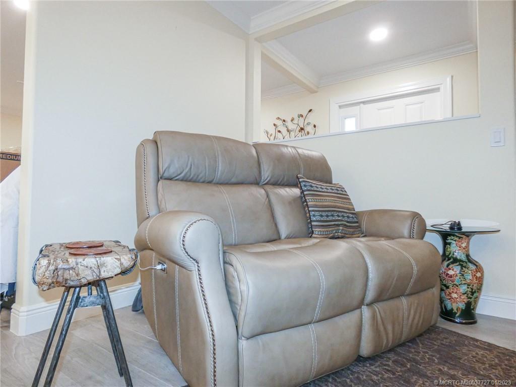 308 Southwest Ridge Lane Stuart, FL 34994 - Photo 10 of 43 a bedroom with a bed and a chandelier