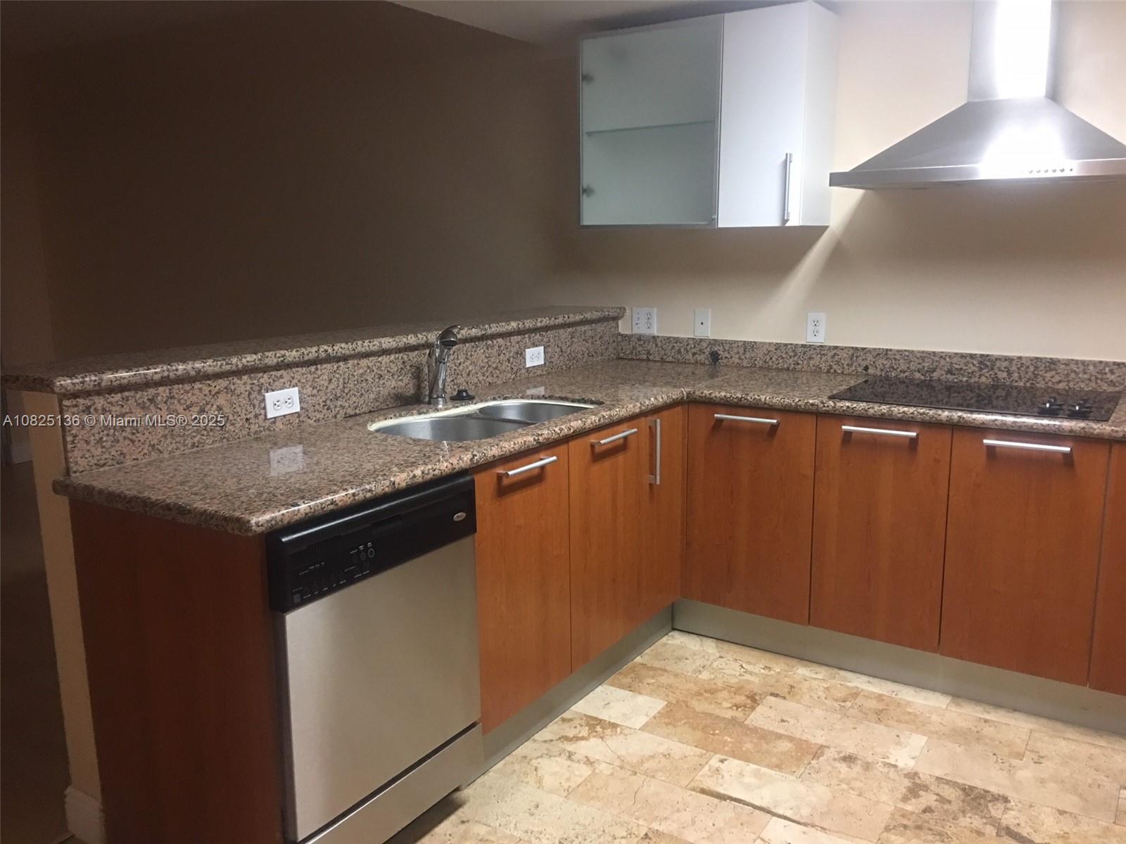 170 Southeast 14th Street, Unit 1407 Miami, FL 33131 - Photo 7 of 25 a kitchen with a sink a stove and cabinets