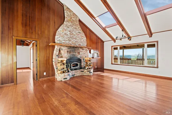 a view of an entryway with wooden floor