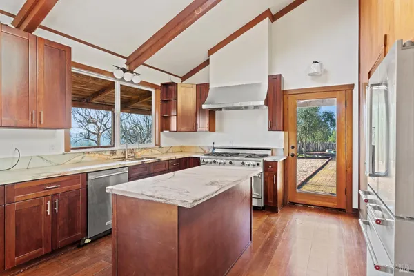 a kitchen with a stove a sink and a refrigerator