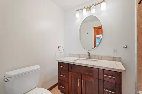 a bathroom with a toilet sink and mirror