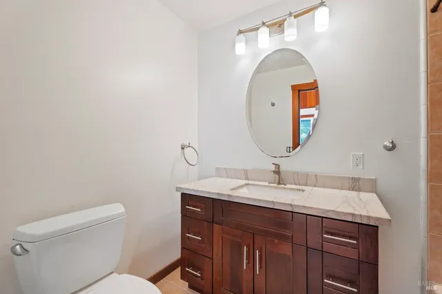 a bathroom with a toilet sink and mirror