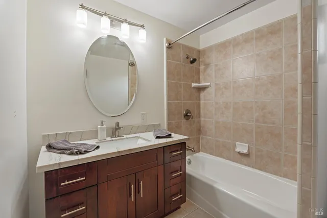 a bathroom with a sink mirror and a bathtub