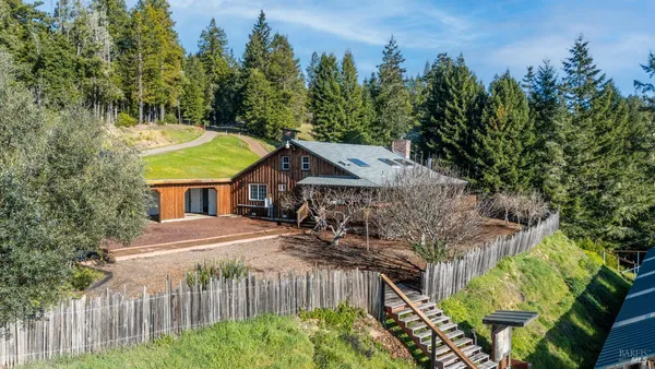 a view of a house with wooden fence