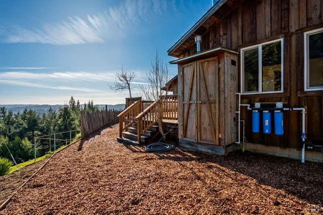 a view of a house with backyard and deck