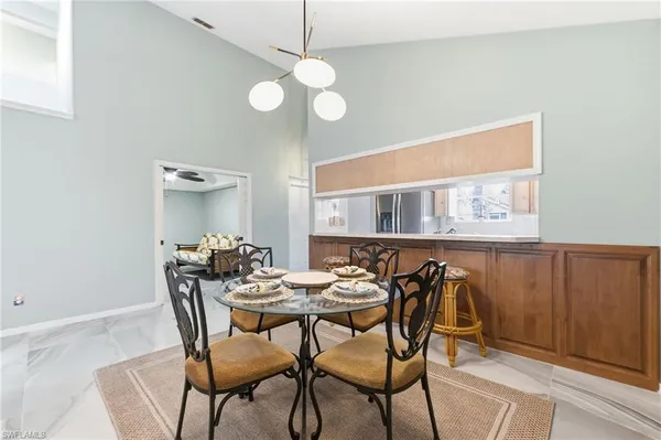 a view of a dining room with furniture and chandelier