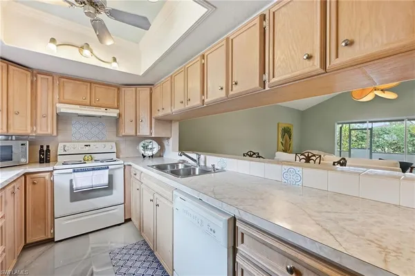 a kitchen with a sink cabinets and window