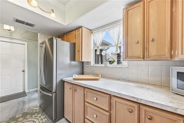 a kitchen with stainless steel appliances granite countertop a refrigerator and a sink