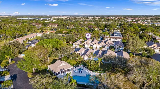 an aerial view of residential houses with outdoor space and trees