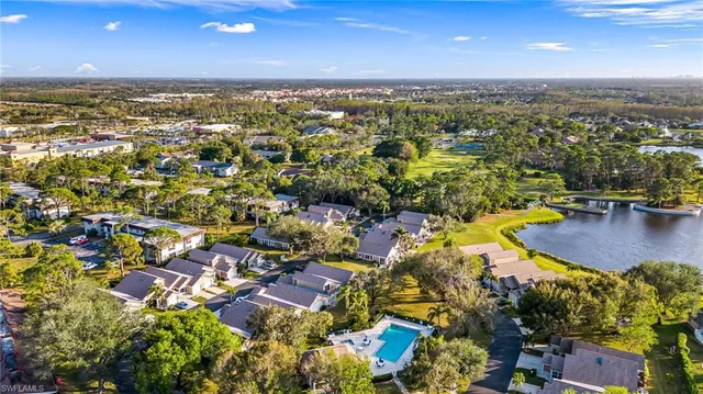 an aerial view of residential houses with outdoor space and swimming pool
