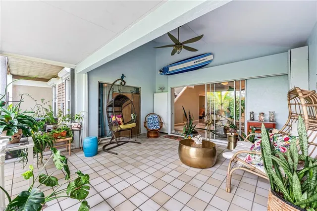 a room with lots of furniture and potted plants