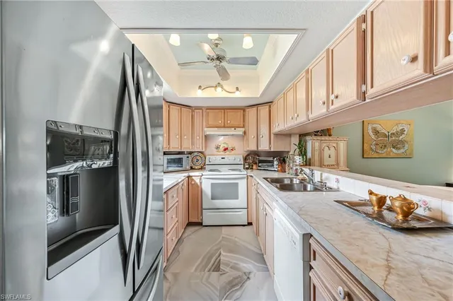 a kitchen with a sink appliances and cabinets
