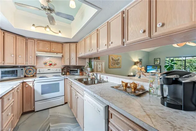a kitchen with cabinets a sink and appliances